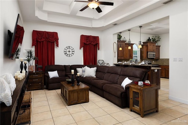 806 Beryl Cir, Weslaco, TX 78596 - living area featuring a tray ceiling, ceiling fan, and light tile patterned floors