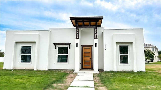 1509 Vida Dulce, Weslaco, TX 78596 - modern home with stucco siding and a front lawn