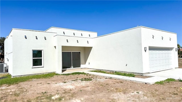 1509 Vida Dulce, Weslaco, TX 78596 - back of house with stucco siding, central AC, and a detached garage
