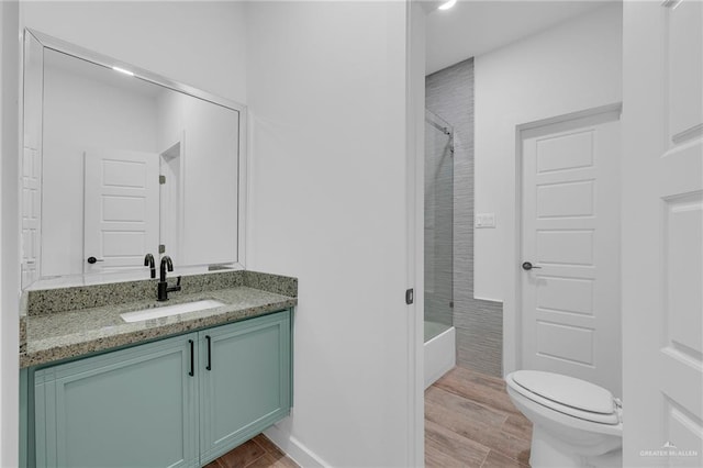 4720 Waterford Ave, Edinburg, TX 78539 - bathroom featuring vanity, wood finished floors, toilet, and  shower combination