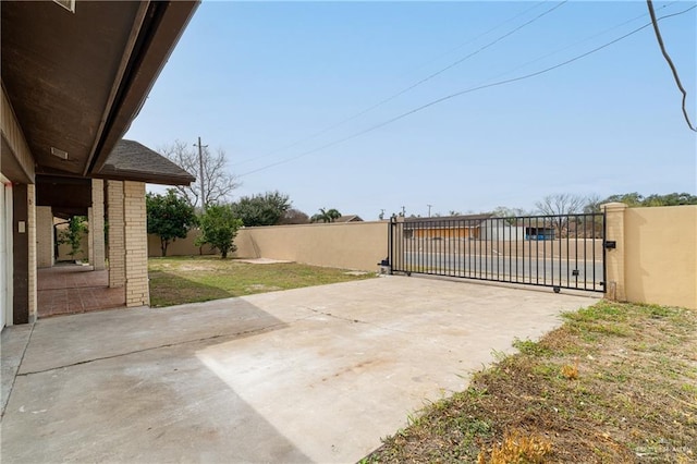view of patio featuring fence and a gate