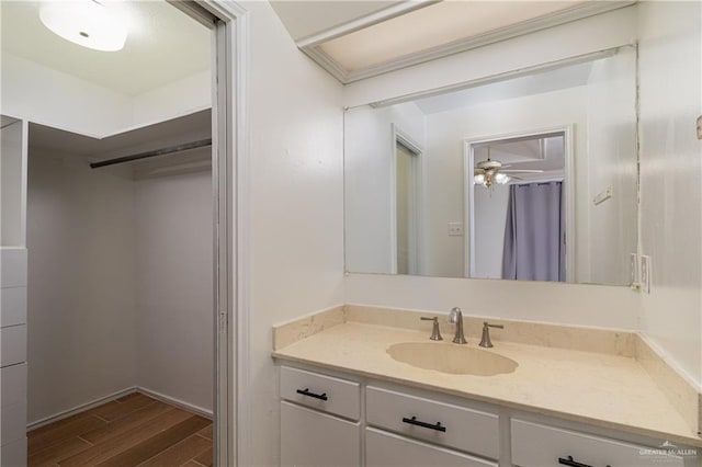bathroom featuring wood finished floors, vanity, and ceiling fan