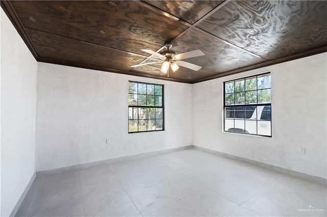 spare room featuring ornamental molding, a healthy amount of sunlight, and wood ceiling