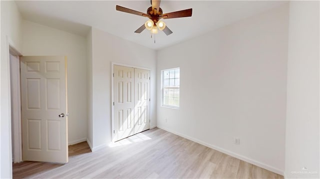 unfurnished bedroom with ceiling fan, light hardwood / wood-style floors, and a closet