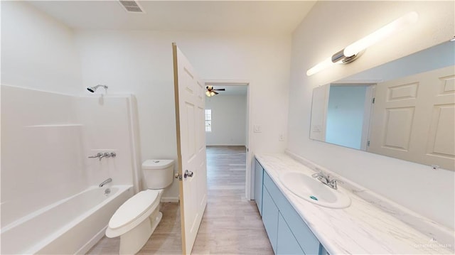 full bathroom featuring vanity, ceiling fan, shower / tub combination, hardwood / wood-style floors, and toilet