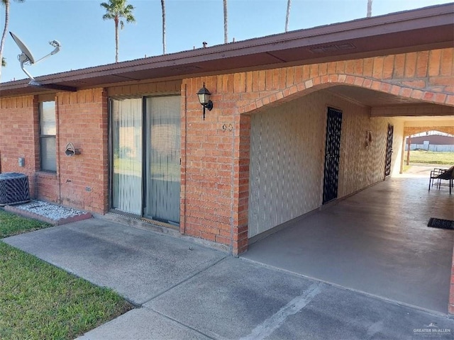 view of exterior entry with central AC unit