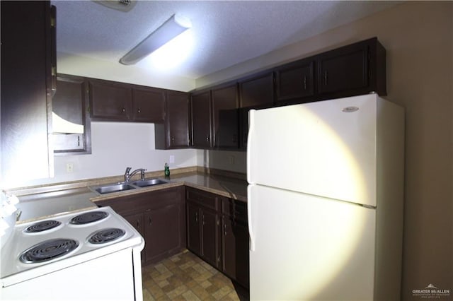 kitchen with a textured ceiling, dark brown cabinetry, white appliances, and sink