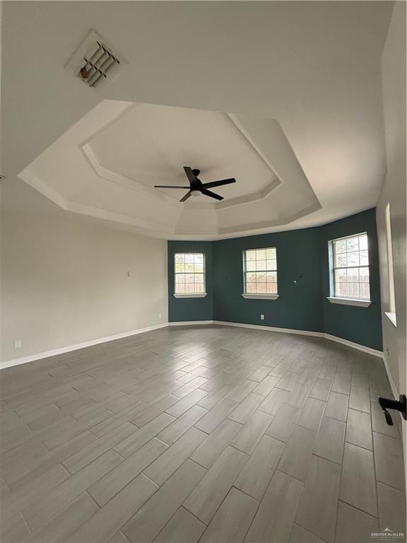 spare room featuring light hardwood / wood-style floors, a wealth of natural light, and ceiling fan