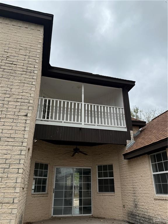 view of home's exterior with ceiling fan and a balcony