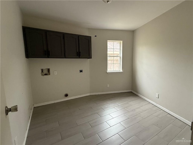 washroom with electric dryer hookup, cabinets, and washer hookup