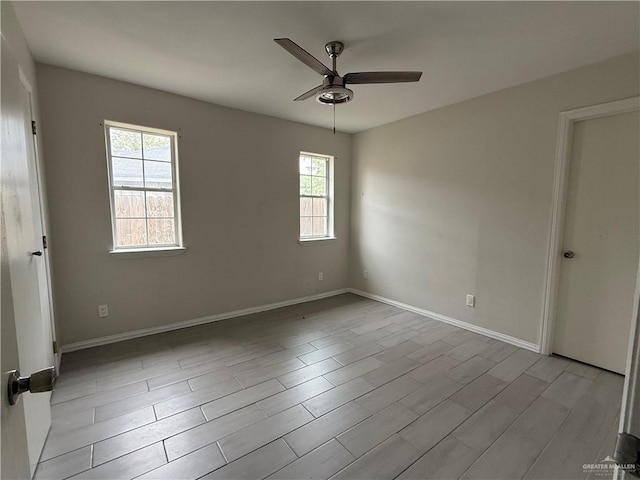 spare room featuring light hardwood / wood-style flooring and ceiling fan