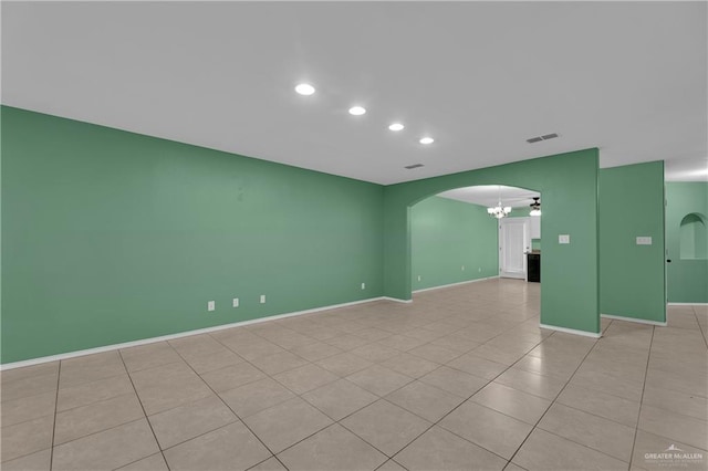 tiled empty room featuring ceiling fan