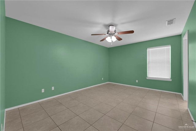 unfurnished room with light tile patterned floors and ceiling fan