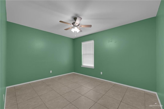 empty room featuring light tile patterned floors and ceiling fan