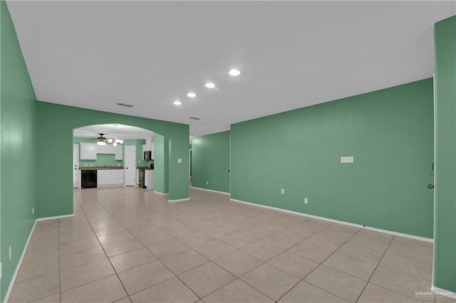 unfurnished living room with light tile patterned floors and a notable chandelier