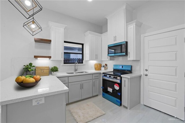 kitchen featuring tasteful backsplash, a sink, white cabinets, stainless steel appliances, and open shelves