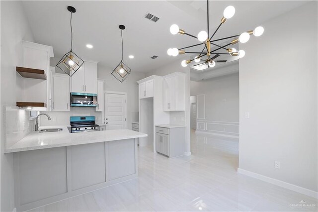 kitchen with visible vents, open shelves, appliances with stainless steel finishes, a peninsula, and a sink