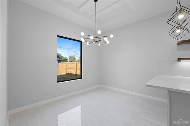 unfurnished dining area featuring baseboards and a chandelier
