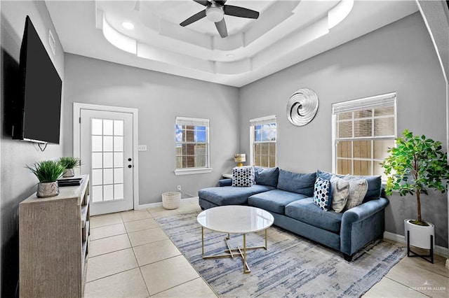 317 Ohara Dr, Pharr, TX 78577 - living room featuring a raised ceiling, ceiling fan, light tile patterned floors, and baseboards