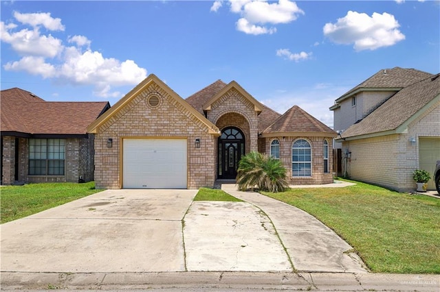 317 Ohara Dr, Pharr, TX 78577 - view of front facade featuring a front yard, brick siding, concrete driveway, a garage, and a shingled roof