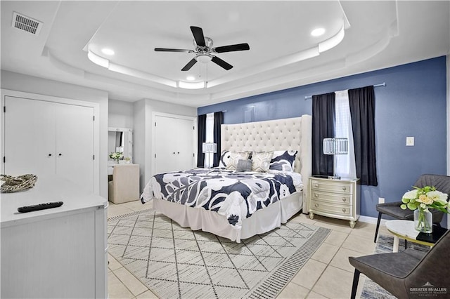 317 Ohara Dr, Pharr, TX 78577 - bedroom with a tray ceiling, light tile patterned floors, recessed lighting, ceiling fan, and multiple closets