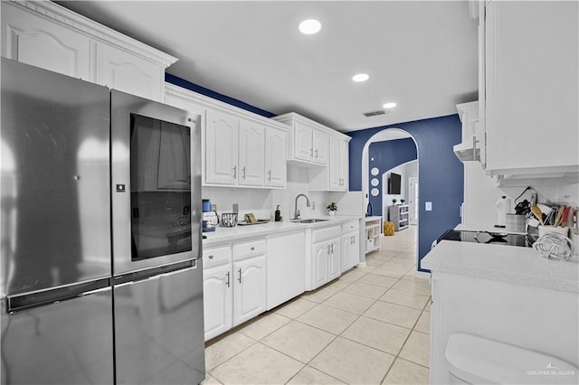 317 Ohara Dr, Pharr, TX 78577 - kitchen featuring smart refrigerator, a sink, arched walkways, light countertops, and recessed lighting