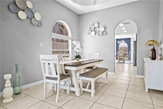 317 Ohara Dr, Pharr, TX 78577 - dining space with light tile patterned flooring, baseboards, and arched walkways