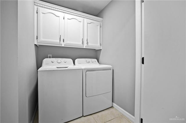 317 Ohara Dr, Pharr, TX 78577 - washroom with separate washer and dryer, cabinet space, baseboards, and light tile patterned flooring