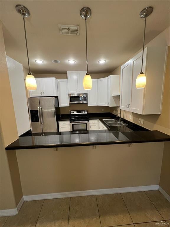 kitchen featuring kitchen peninsula, sink, hanging light fixtures, and appliances with stainless steel finishes