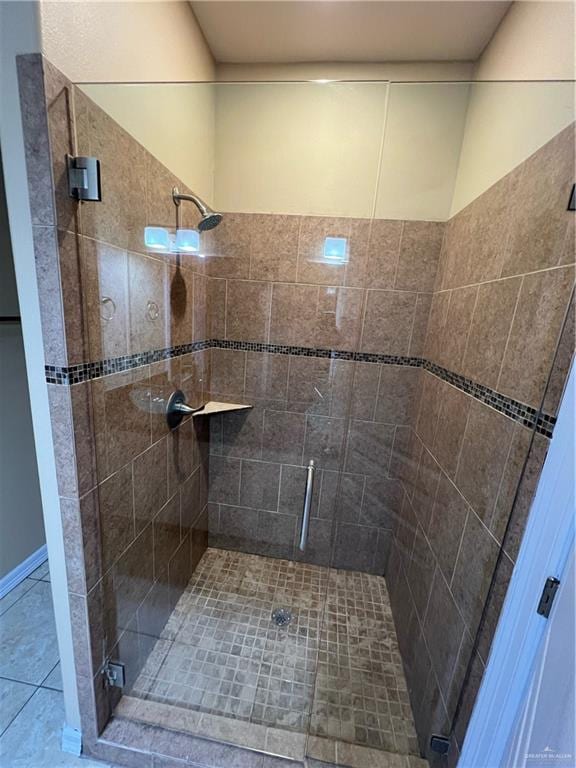 bathroom featuring tile patterned flooring and a shower with shower door