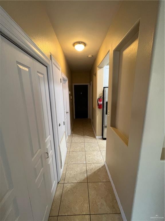 hallway featuring light tile patterned flooring