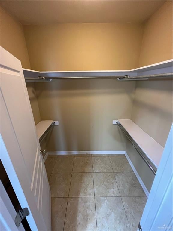 spacious closet featuring light tile patterned floors