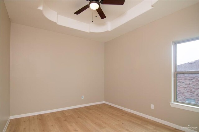 3608 Morris St, Edinburg, TX 78542 - unfurnished room featuring a tray ceiling, light wood-style flooring, and a ceiling fan