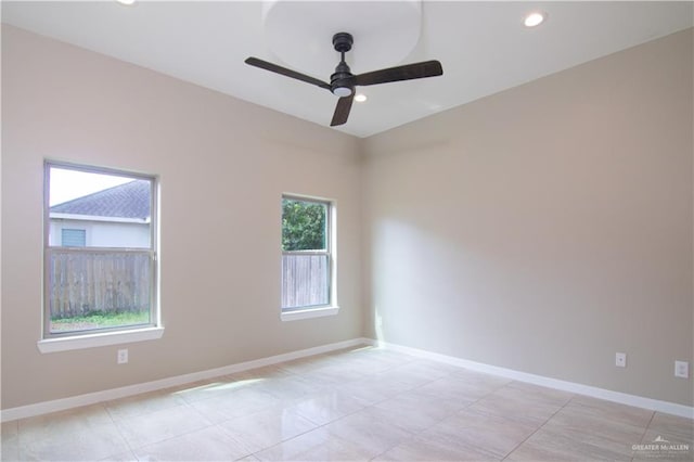 spare room with ceiling fan and light tile patterned flooring