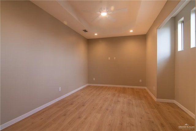 3608 Morris St, Edinburg, TX 78542 - empty room featuring light wood-style flooring, recessed lighting, ceiling fan, and a tray ceiling