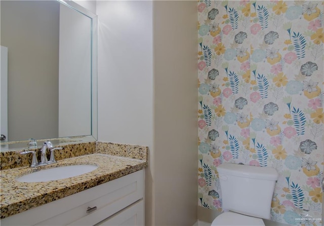 bathroom featuring vanity and toilet