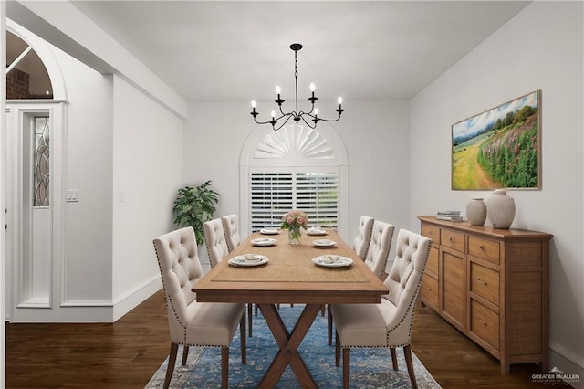 dining room with dark hardwood / wood-style floors and a chandelier