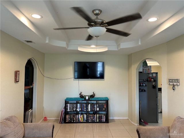 8601 Las Palmas Dr, Pharr, TX 78577 - living room with a raised ceiling, arched walkways, ceiling fan, and tile patterned flooring