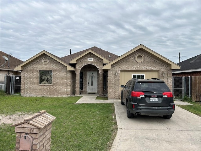 8601 Las Palmas Dr, Pharr, TX 78577 - view of front facade with a front yard, fence, a gate, brick siding, and concrete driveway