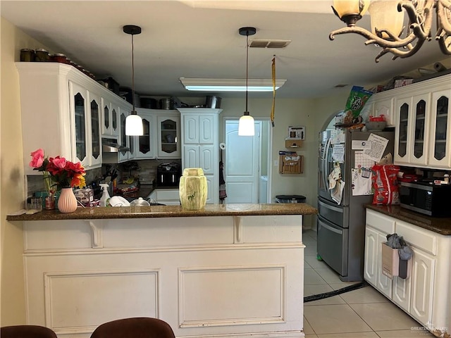 8601 Las Palmas Dr, Pharr, TX 78577 - kitchen with a peninsula, glass insert cabinets, light tile patterned flooring, extractor fan, and appliances with stainless steel finishes