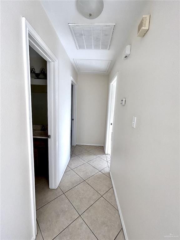 hall with light tile patterned floors