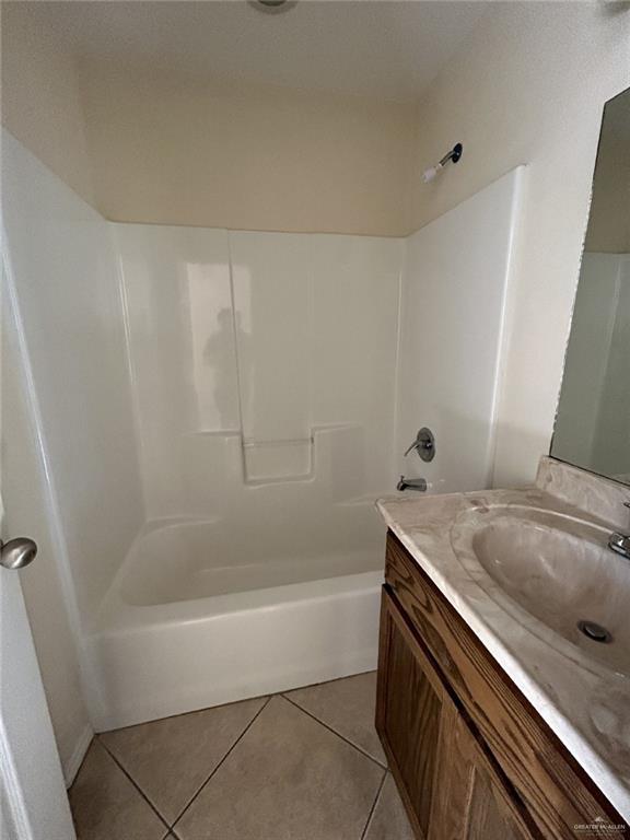 bathroom with tile patterned floors, vanity, and tub / shower combination