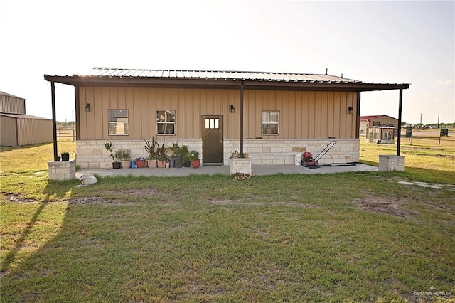 rear view of house with a yard