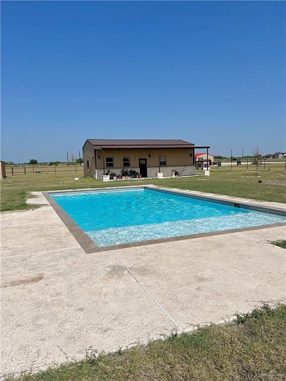 view of swimming pool featuring a yard and a patio