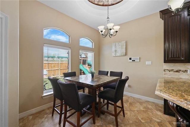 dining room with an inviting chandelier and baseboards