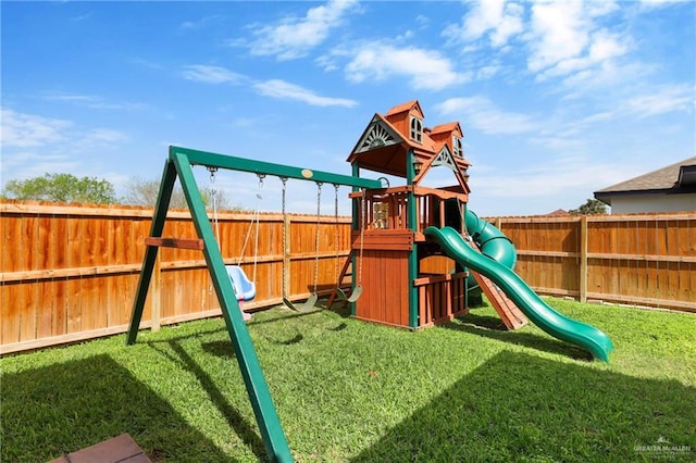 view of playground featuring a lawn and a fenced backyard