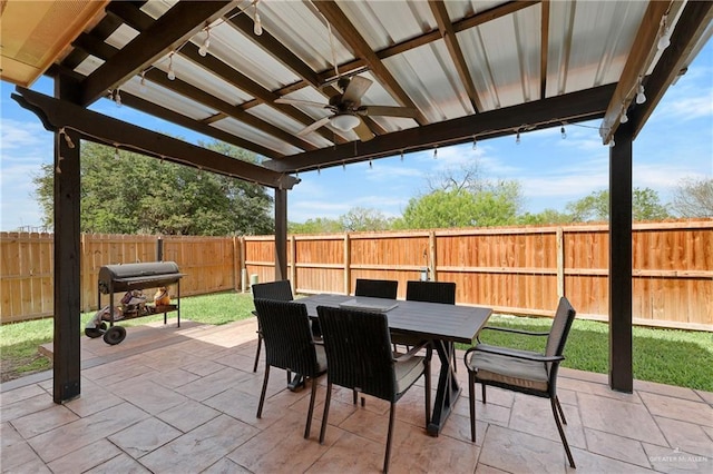 view of patio / terrace featuring ceiling fan, area for grilling, a fenced backyard, and outdoor dining space