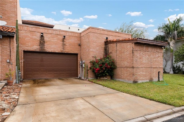 exterior space with a garage and a lawn