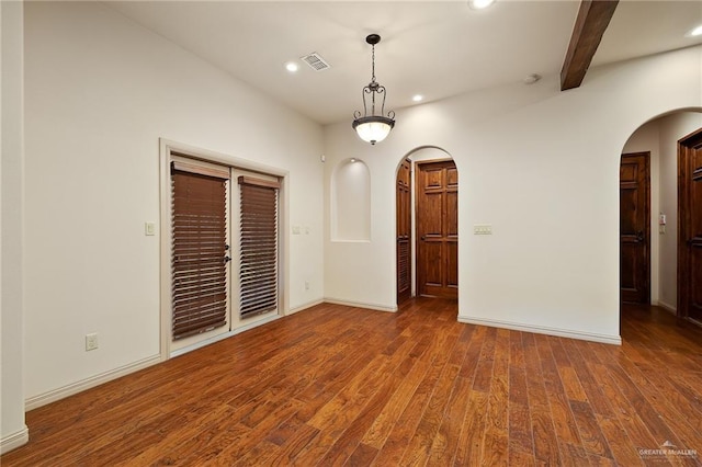 interior space with beam ceiling and dark wood-type flooring