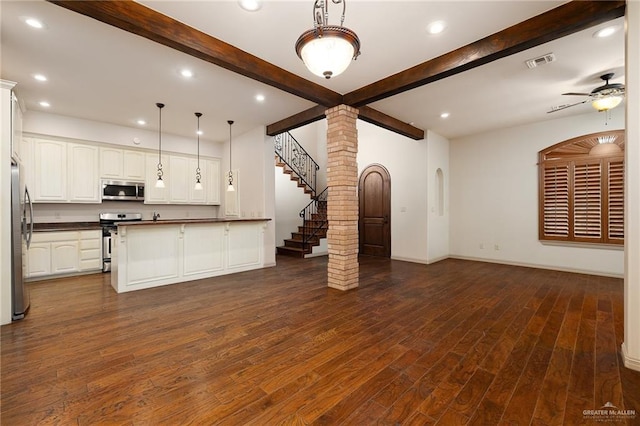 kitchen with appliances with stainless steel finishes, decorative light fixtures, white cabinetry, dark hardwood / wood-style flooring, and beam ceiling